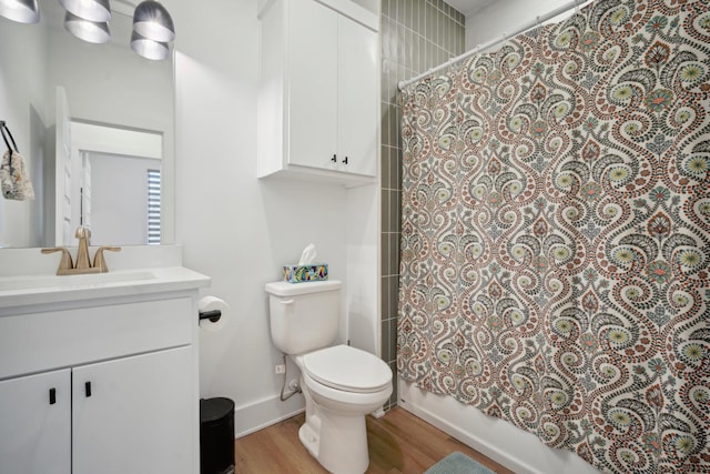 full bathroom featuring vanity, shower / tub combo, hardwood / wood-style flooring, and toilet