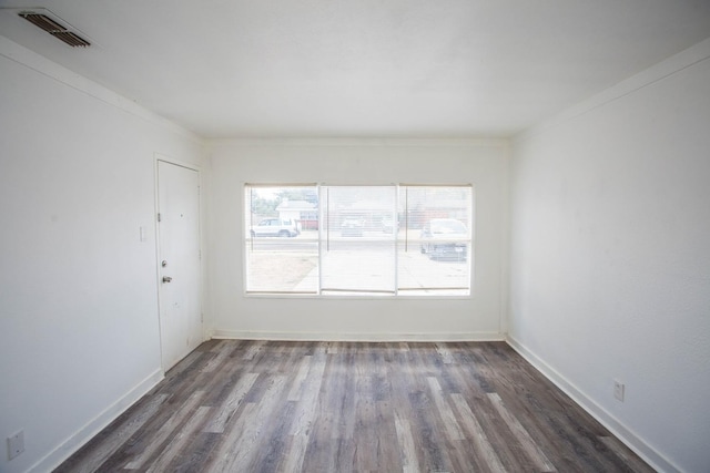 spare room featuring dark wood-type flooring