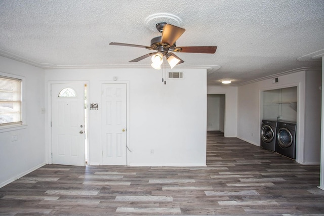 foyer with ceiling fan, independent washer and dryer, dark hardwood / wood-style flooring, and a textured ceiling