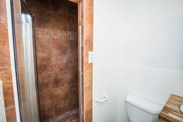 bathroom with walk in shower, toilet, and tile walls