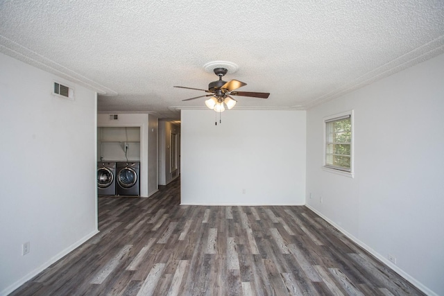 spare room with ceiling fan, dark hardwood / wood-style flooring, washing machine and dryer, and a textured ceiling