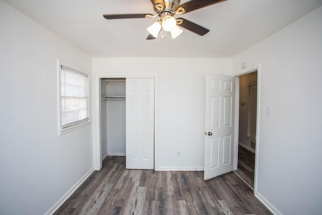 unfurnished bedroom featuring ceiling fan, dark hardwood / wood-style flooring, and a closet