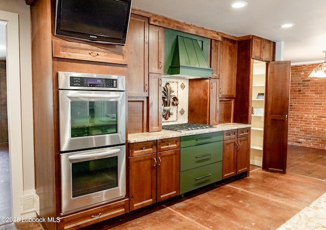 5412 20th St, Lubbock, TX 79407 - kitchen with appliances with stainless steel finishes, custom exhaust hood, brick wall, light stone countertops, and recessed lighting