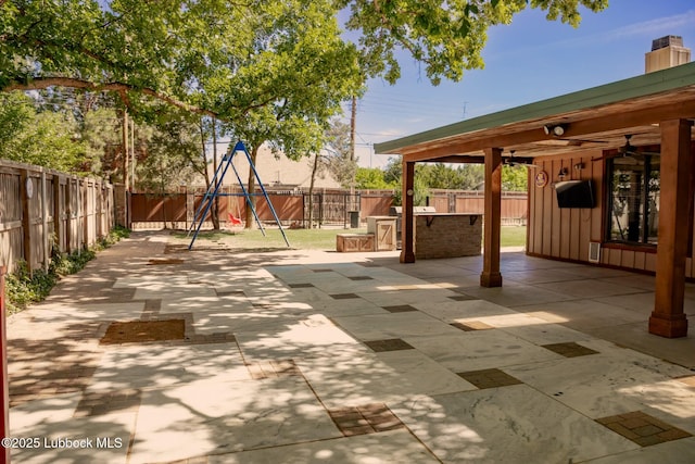 5412 20th St, Lubbock, TX 79407 - fenced backyard featuring a patio, a playground, and a ceiling fan