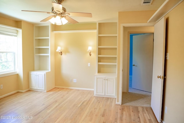 5412 20th St, Lubbock, TX 79407 - empty room featuring light wood-style floors, built in features, ceiling fan, and baseboards