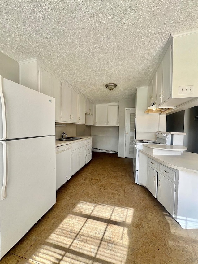 kitchen featuring white cabinetry, sink, a textured ceiling, and white appliances