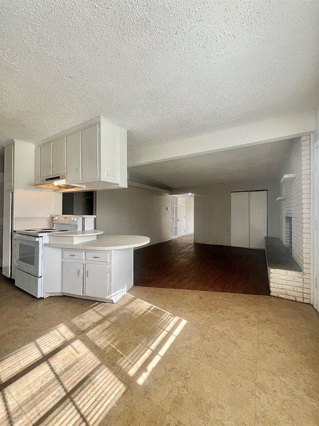 kitchen with white cabinetry, a fireplace, a textured ceiling, and white range with electric cooktop