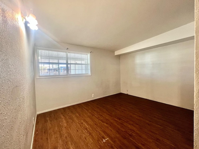 spare room with dark wood-type flooring