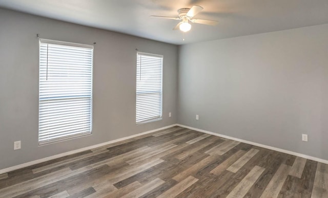 empty room with dark hardwood / wood-style floors and ceiling fan