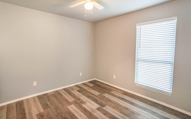 empty room with hardwood / wood-style flooring and ceiling fan