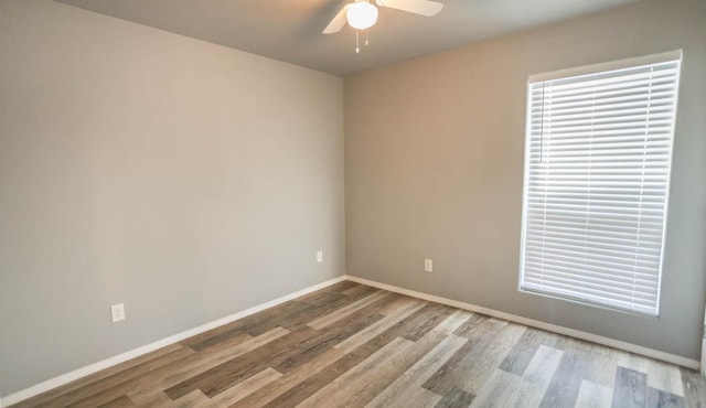 empty room with light hardwood / wood-style flooring and ceiling fan