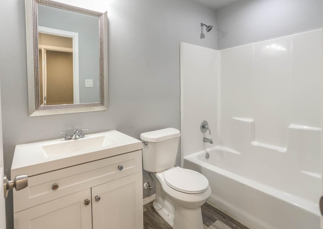 full bathroom featuring wood-type flooring, shower / washtub combination, vanity, and toilet