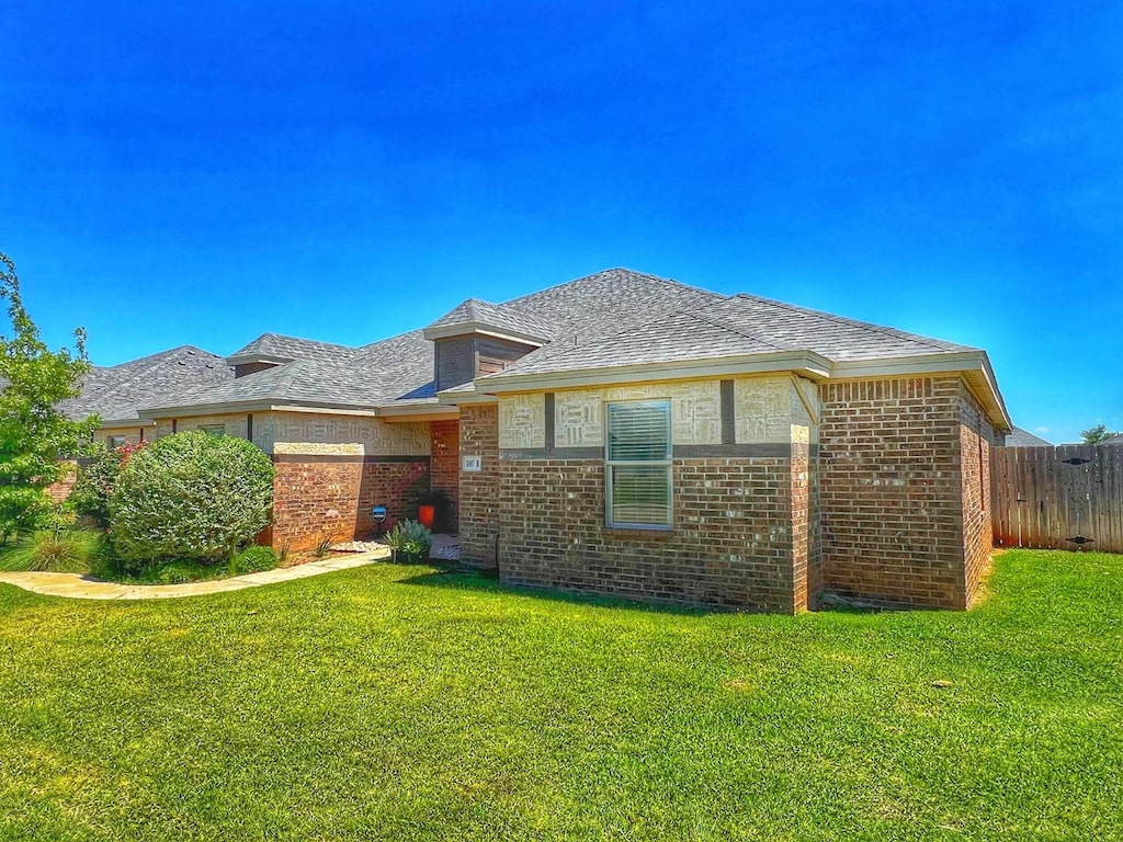 rear view of house with a yard