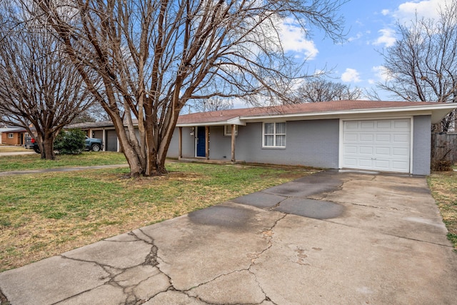 ranch-style house featuring a garage and a front lawn