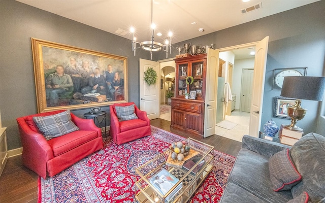 living room featuring a chandelier and dark hardwood / wood-style flooring