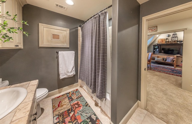 full bathroom with shower / bath combination with curtain, tile patterned floors, vanity, and toilet