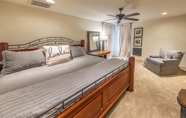 bedroom with ceiling fan and light colored carpet