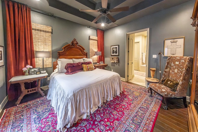 bedroom featuring ceiling fan, hardwood / wood-style floors, and ensuite bath