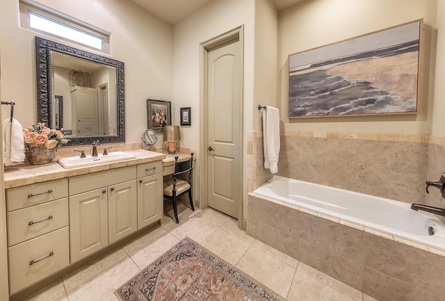 bathroom with vanity, tile patterned flooring, and tiled tub