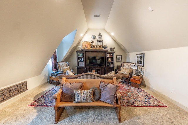 sitting room with vaulted ceiling and carpet flooring