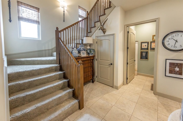 staircase featuring tile patterned flooring