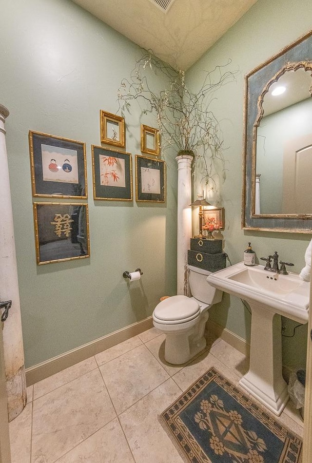 bathroom with tile patterned flooring, sink, and toilet