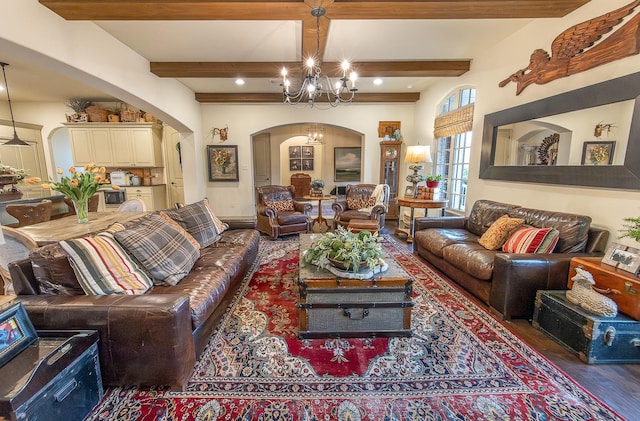 living room with beamed ceiling, dark hardwood / wood-style floors, and an inviting chandelier