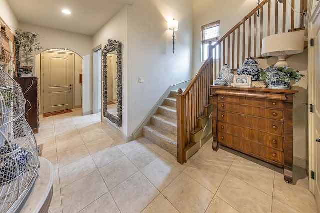 staircase featuring tile patterned flooring