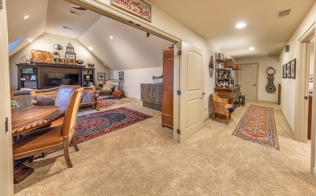 office area with light colored carpet and vaulted ceiling