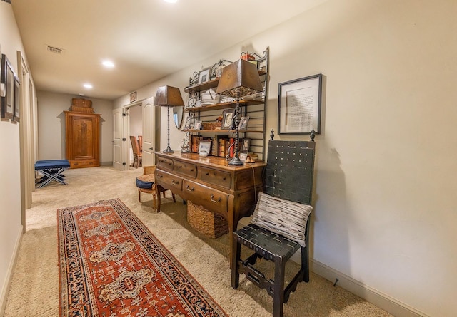 living area with light colored carpet