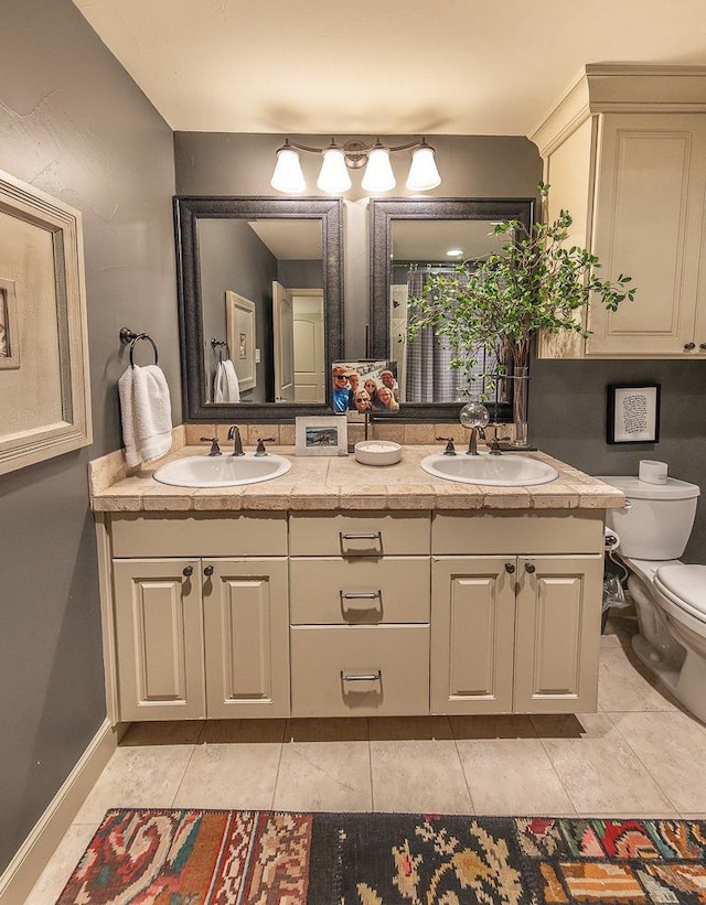 bathroom featuring tile patterned flooring, vanity, and toilet