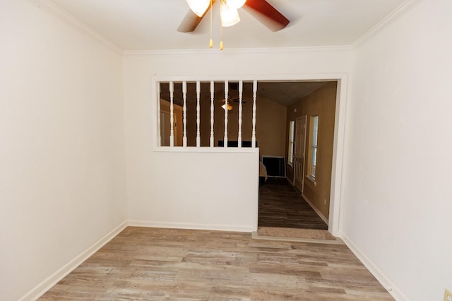 empty room with crown molding, light hardwood / wood-style flooring, and ceiling fan