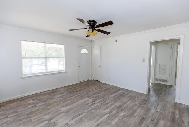 empty room with ornamental molding, ceiling fan, and light hardwood / wood-style floors