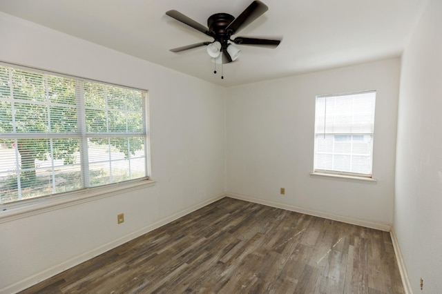 unfurnished room featuring dark wood-type flooring and ceiling fan