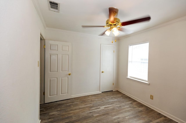 spare room featuring crown molding, ceiling fan, and dark hardwood / wood-style flooring