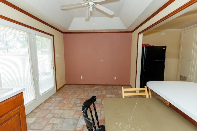 unfurnished dining area featuring ornamental molding, ceiling fan, and a tray ceiling