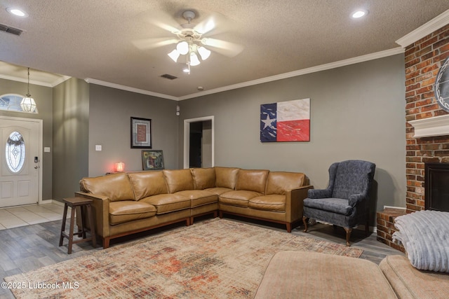 5516 101st Pl, Lubbock, TX 79424 - living area with a ceiling fan, wood finished floors, a fireplace, a textured ceiling, and recessed lighting