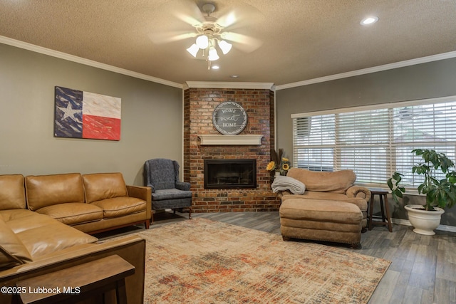 5516 101st Pl, Lubbock, TX 79424 - living area with a ceiling fan, a textured ceiling, wood finished floors, a brick fireplace, and crown molding