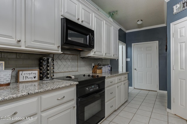 5516 101st Pl, Lubbock, TX 79424 - kitchen with black microwave, range with electric cooktop, light tile patterned floors, white cabinets, and decorative backsplash