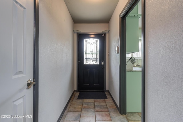 2608 74th Pl, Lubbock, TX 79423 - entryway with stone finish floors, healthy amount of natural light, and a textured wall