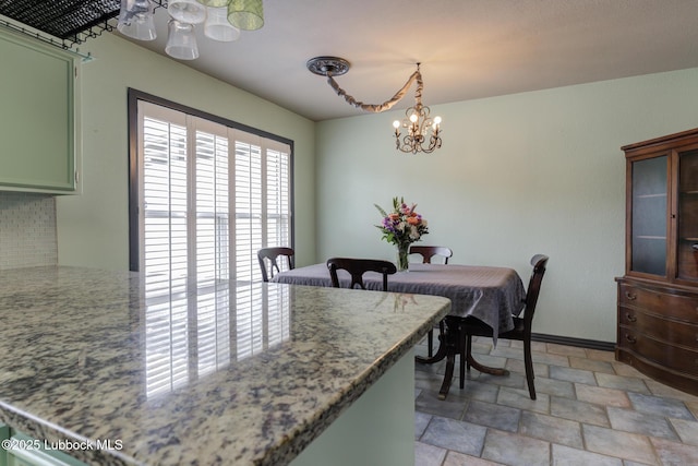 2608 74th Pl, Lubbock, TX 79423 - dining space featuring stone finish flooring and a chandelier