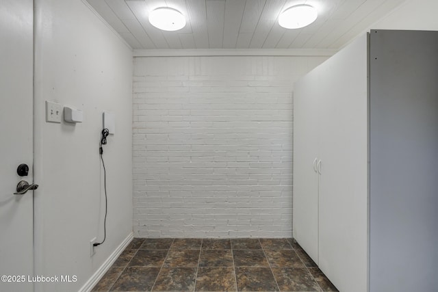 2608 74th Pl, Lubbock, TX 79423 - interior space featuring brick wall and dark stone finish flooring