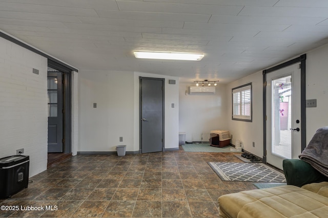 2608 74th Pl, Lubbock, TX 79423 - living room featuring a wall unit AC and stone finish floors