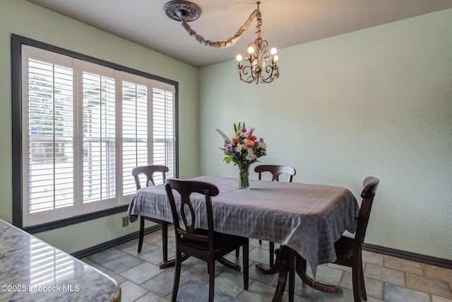 2608 74th Pl, Lubbock, TX 79423 - dining area with baseboards and a chandelier