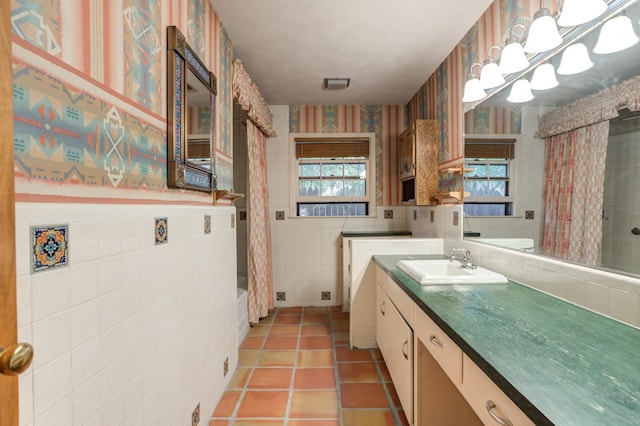 bathroom featuring tile walls, vanity, tile patterned floors, and shower / bath combo