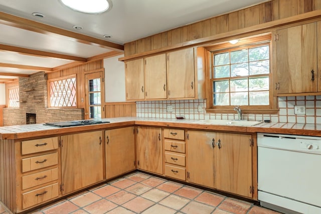 kitchen featuring sink, tile counters, white dishwasher, beamed ceiling, and black gas stovetop