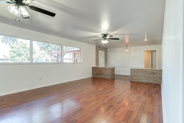 unfurnished living room with dark wood-type flooring and ceiling fan