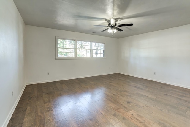 spare room with ceiling fan and dark hardwood / wood-style floors