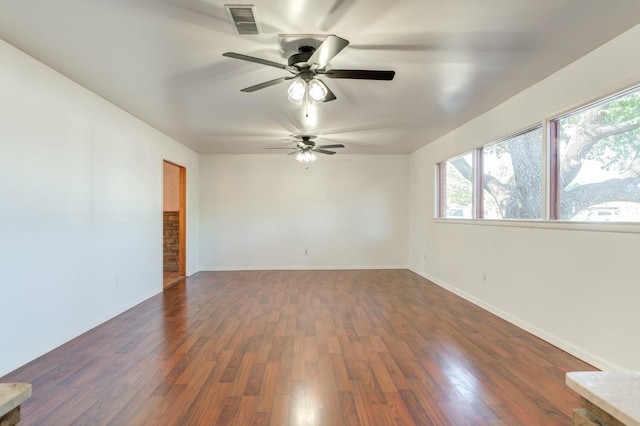 unfurnished room featuring dark hardwood / wood-style flooring and ceiling fan