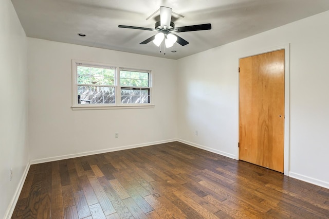 unfurnished room featuring dark wood-type flooring and ceiling fan